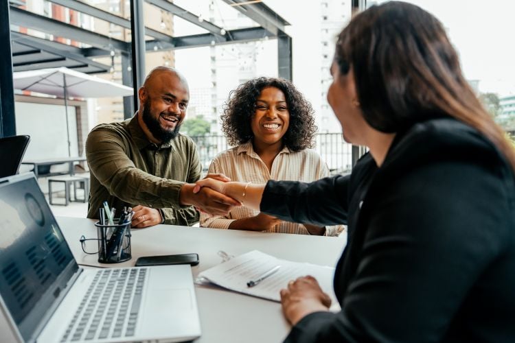 couple shaking hands with an advisor